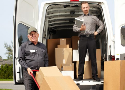 Local movers loading furniture and boxes for transport