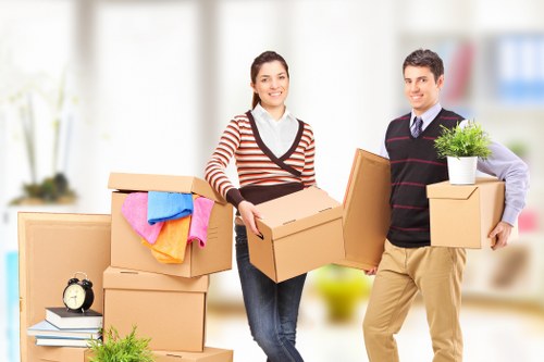 Professional movers unloading household items at a Ponders End property