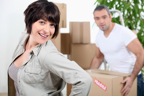 Removal workers handling equipment during a commercial relocation